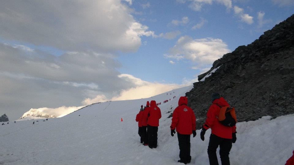People in red jackets in an antarctica landscape