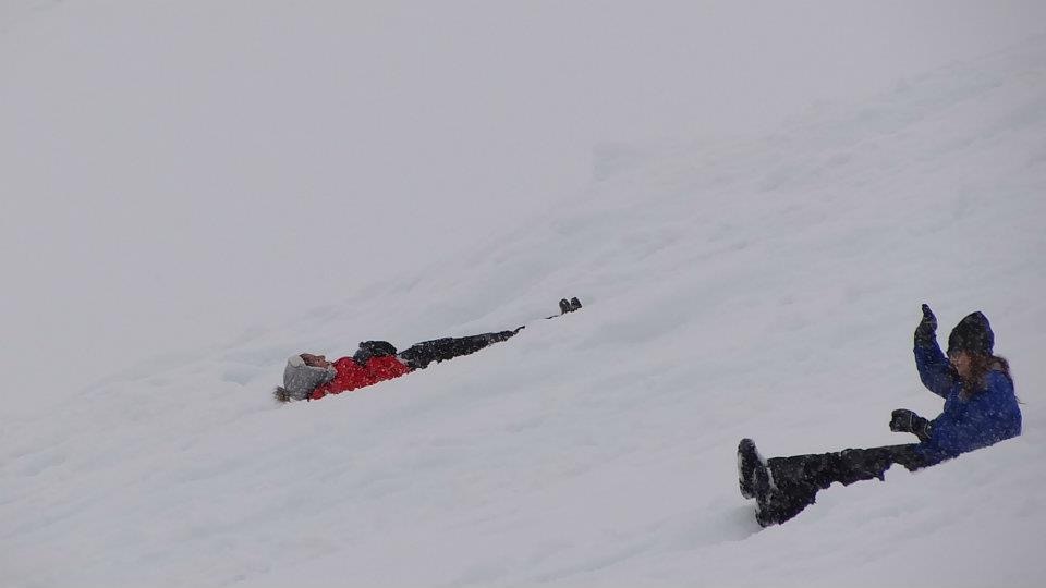 Woman sliding backwards in Antarctica