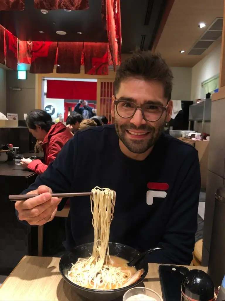 Man eating Ramen noodles in the Tokyo train station, Japan, or goku soup