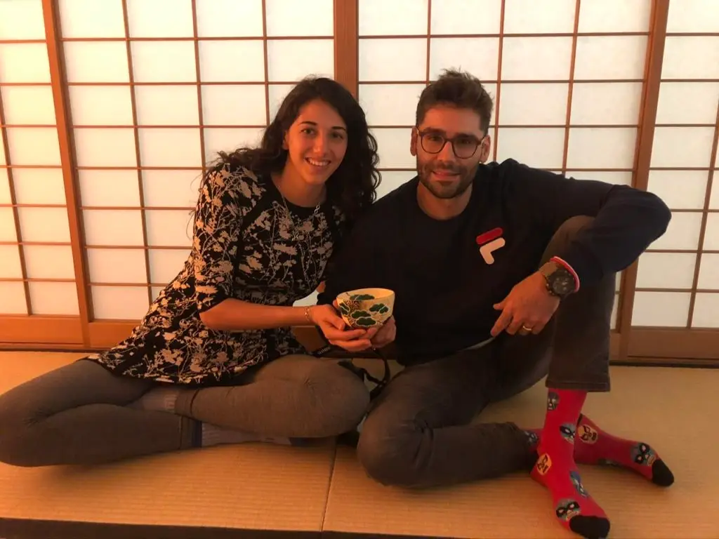 Woman and man holding a traditional Japanese cup they prepared during a tea Ceremony 