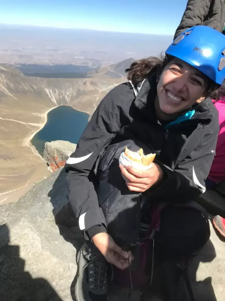 Me happily eating a sandwich on top of the summit of Nevado de Toluca overlooking the lake