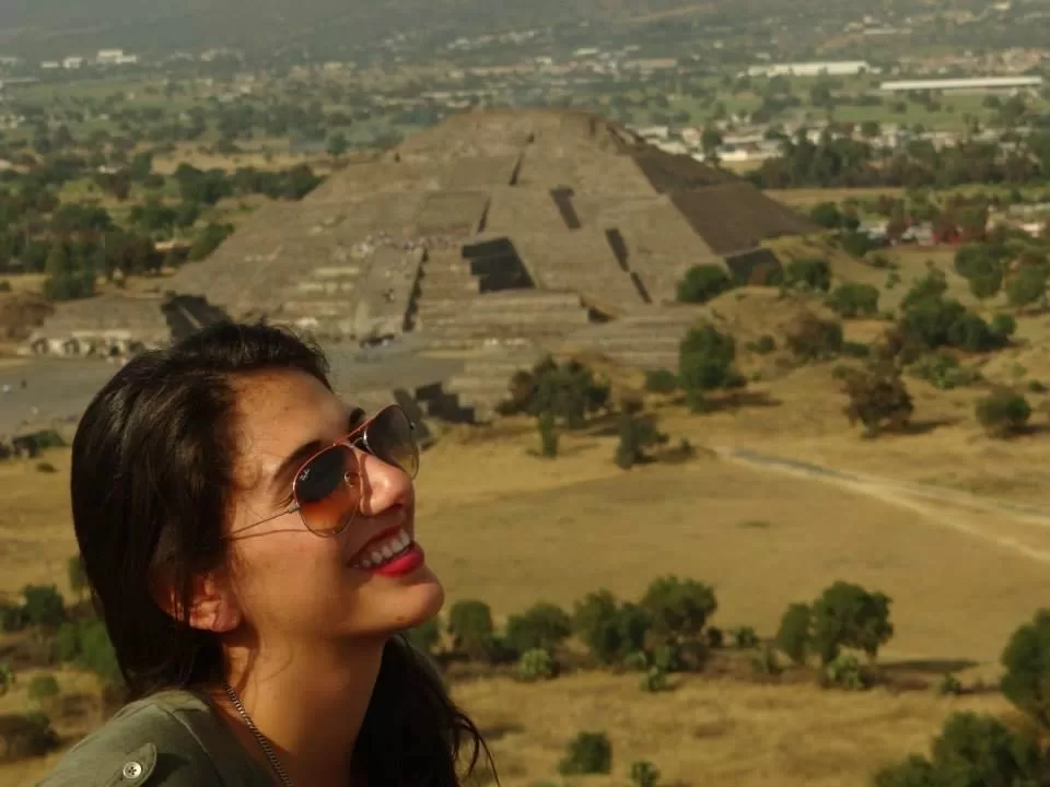 Me on top of the pyramid of the sun with the pyramid of the moon in the background
