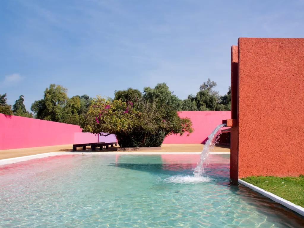 horse pool with fountain and pink wall behind at Cuadra San Cristobal built by Luis Barragan
