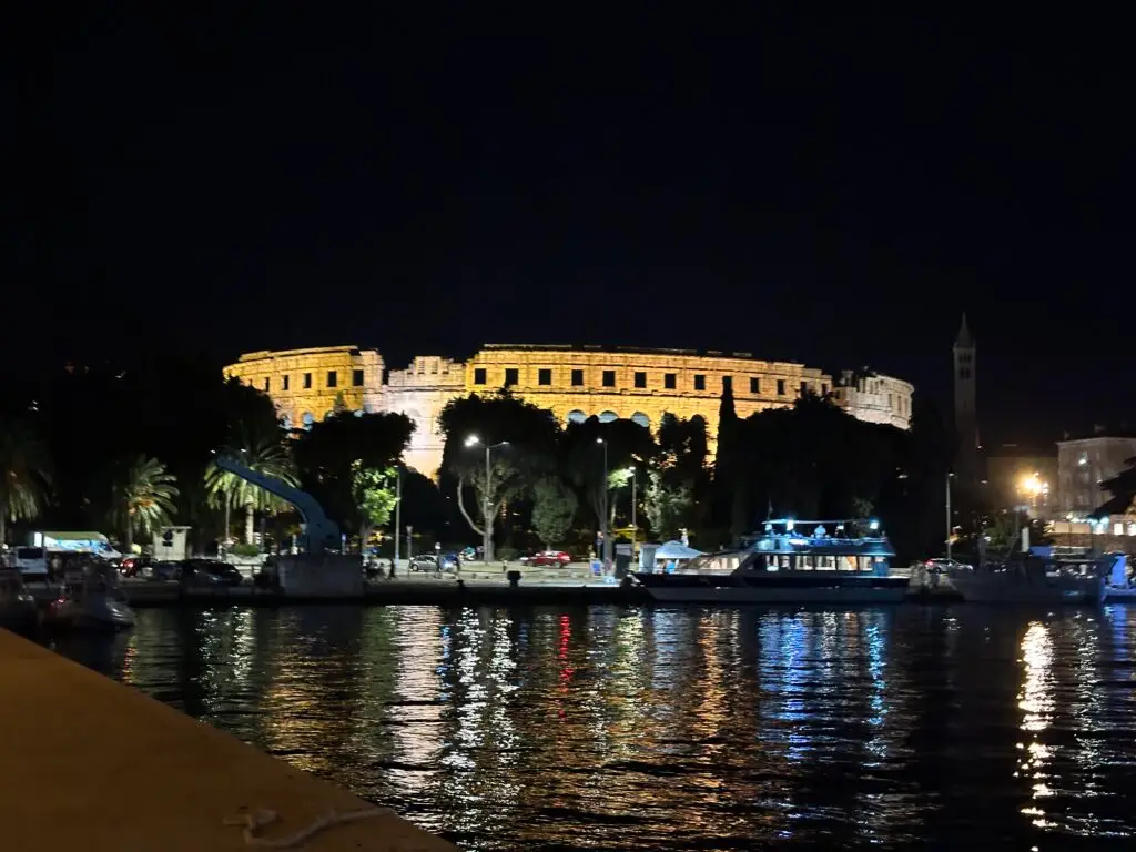 Pula Arena or Pula Amphitheater lit up at night