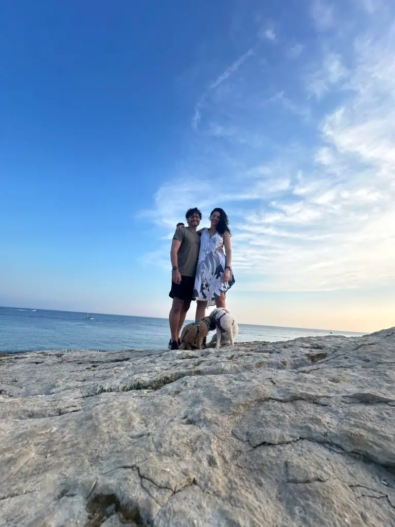 Man, woman and two dogs in cape kamenjak for croatia with dogs