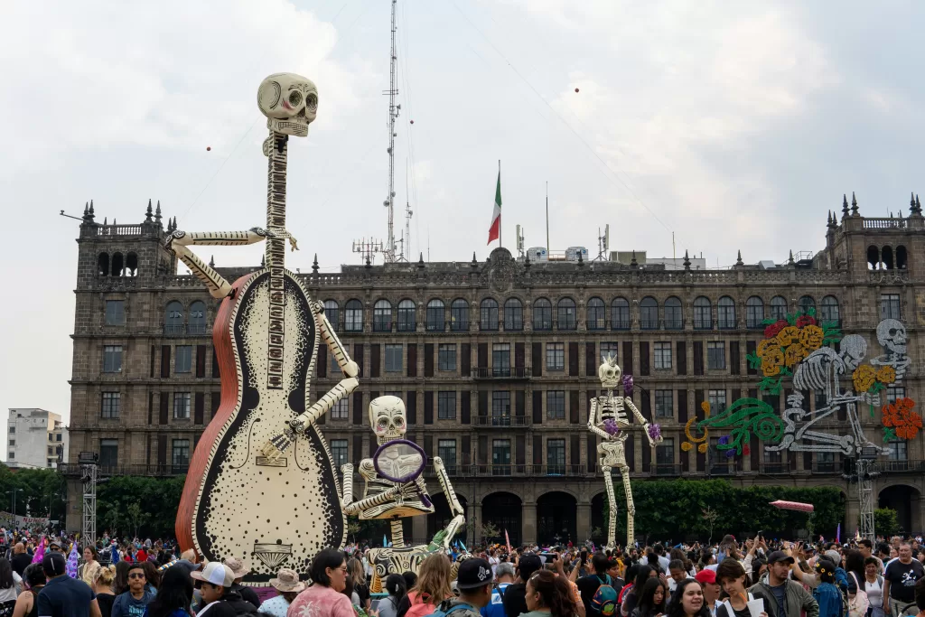 Zocalo with dia de muertos celebrations and altars. Three big skeletons