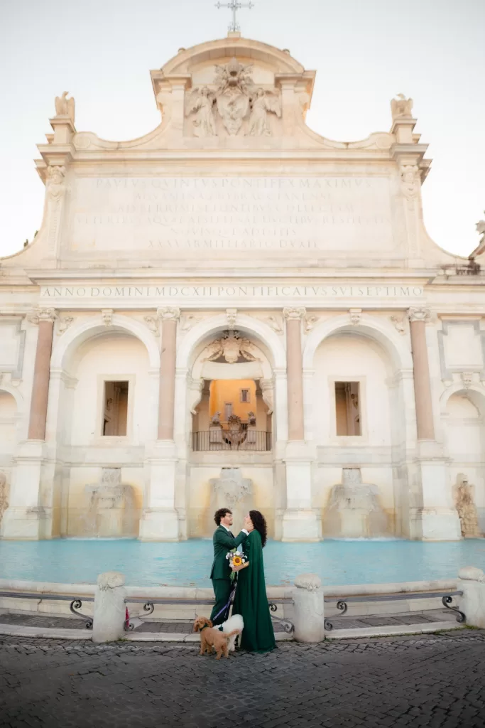 Fontana del acqua paola o fontantone in Rome with me and my husband dressed in green for our wedding photos with our two dogs