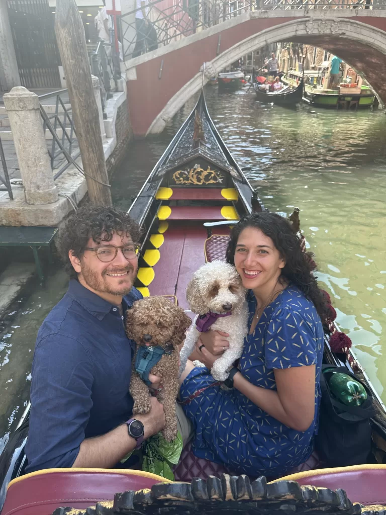 My husband two dogs and I on a gondola ride in Venice while traveling Italy with our dogs