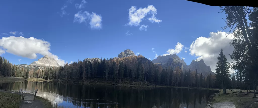 Lago di Antorno with trees turning into fall foliage and mountains in the background on our way cadini di misurina