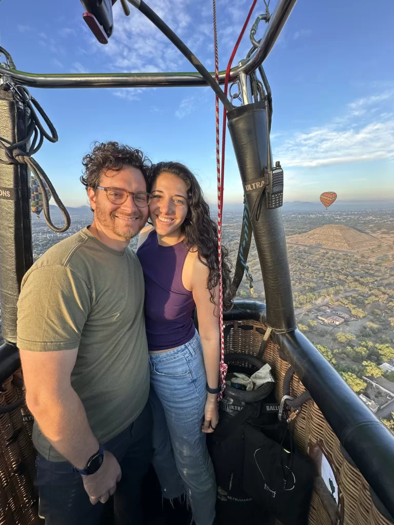 My husband and I inside a hot air balloon basket on top of Teotihuacan on our hot air ballon ride in mexico city