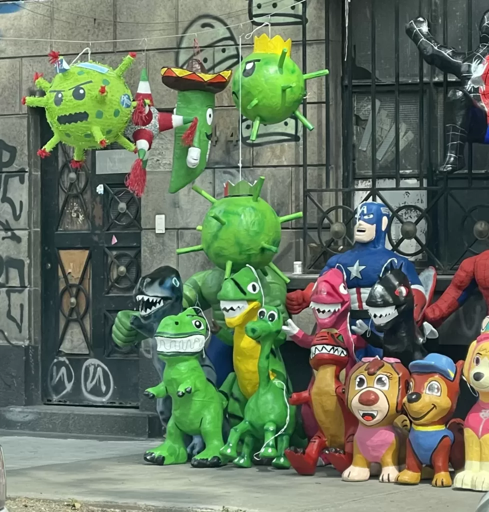 Assorted selection of pinatas in mexico city including covid virus