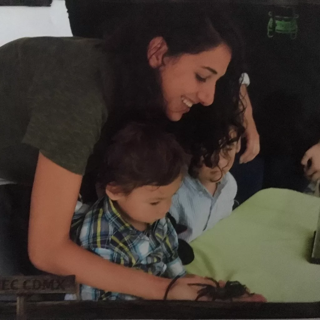 Holding a tarantula with a toddler at the mariposario of the Chapultepec Zoo in Mexico City