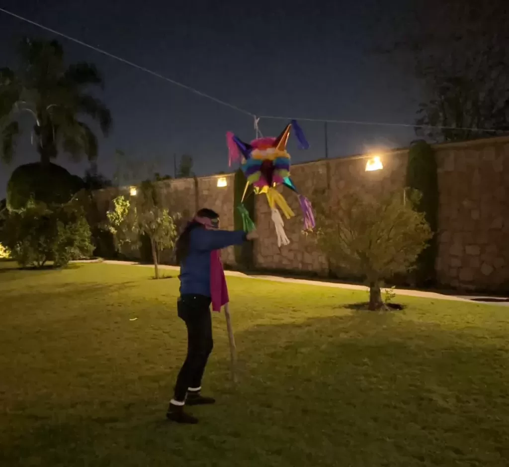 Me with my eyes covered hitting a christmas pinata
